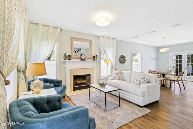 39 Barrington Ave, Bluffton, SC 29910 - living room with french doors, wood finished floors, a fireplace with flush hearth, and visible vents
