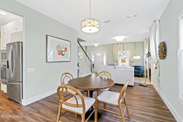 39 Barrington Ave, Bluffton, SC 29910 - dining space featuring baseboards, visible vents, wood finished floors, and stairway
