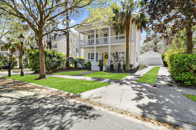 39 Barrington Ave, Bluffton, SC 29910 - view of front facade with a balcony, a front yard, covered porch, and a detached garage