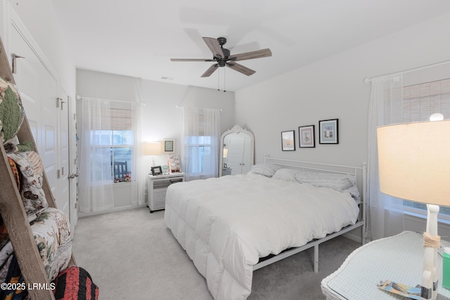 bedroom with light colored carpet and ceiling fan