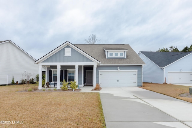 view of front of house featuring a garage, a front yard, and covered porch