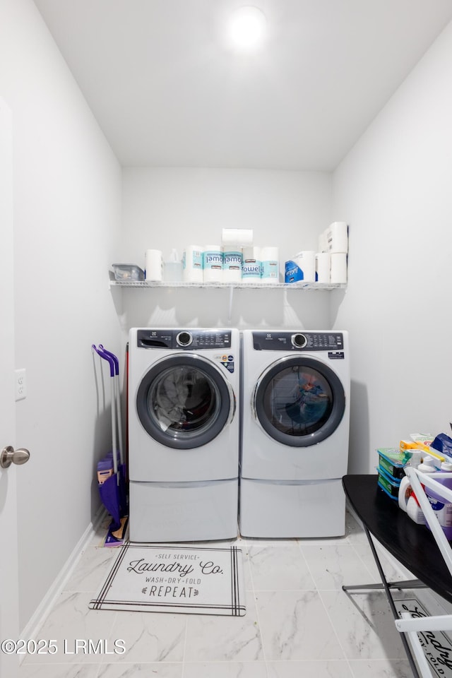 clothes washing area featuring washer and clothes dryer