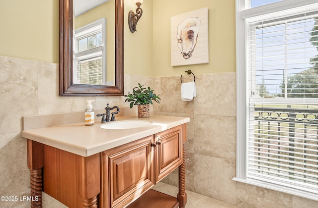 54 Battery Creek Club Dr, Beaufort, SC 29902 - bathroom with a wainscoted wall, tile walls, a healthy amount of sunlight, and vanity