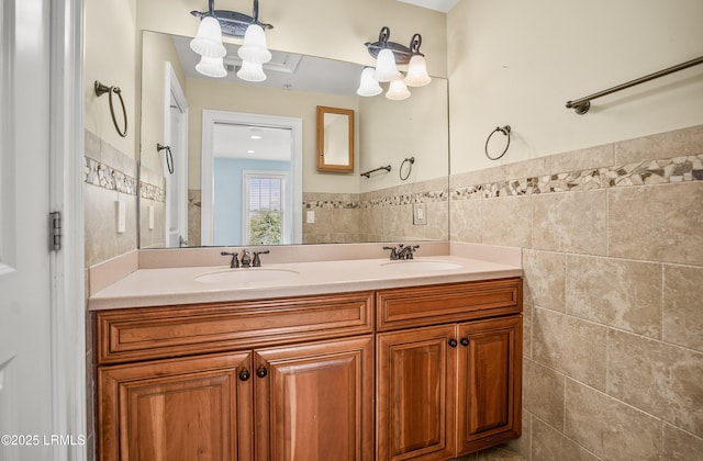 54 Battery Creek Club Dr, Beaufort, SC 29902 - bathroom featuring tile walls, double vanity, a wainscoted wall, and a sink