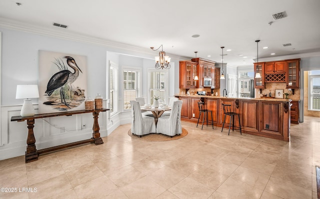 54 Battery Creek Club Dr, Beaufort, SC 29902 - dining room featuring crown molding, a notable chandelier, visible vents, and wainscoting