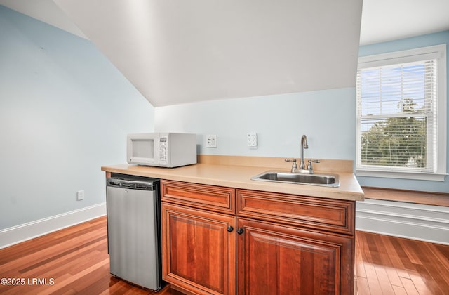 54 Battery Creek Club Dr, Beaufort, SC 29902 - kitchen featuring white microwave, light countertops, lofted ceiling, wood finished floors, and a sink