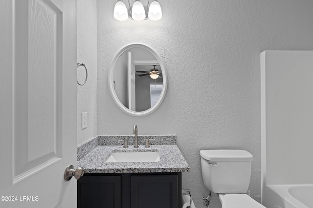 bathroom featuring vanity, a bath, and toilet