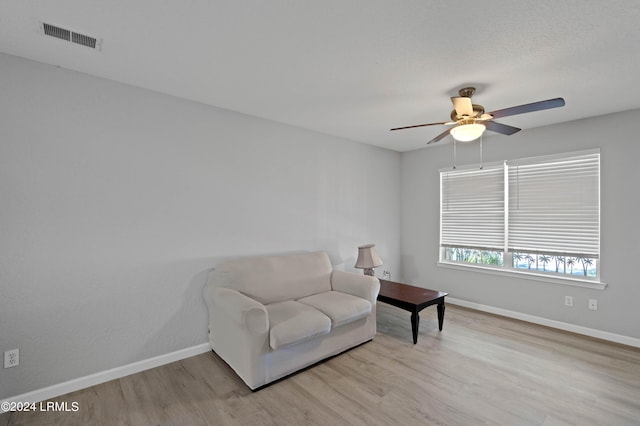 sitting room with ceiling fan and light hardwood / wood-style floors