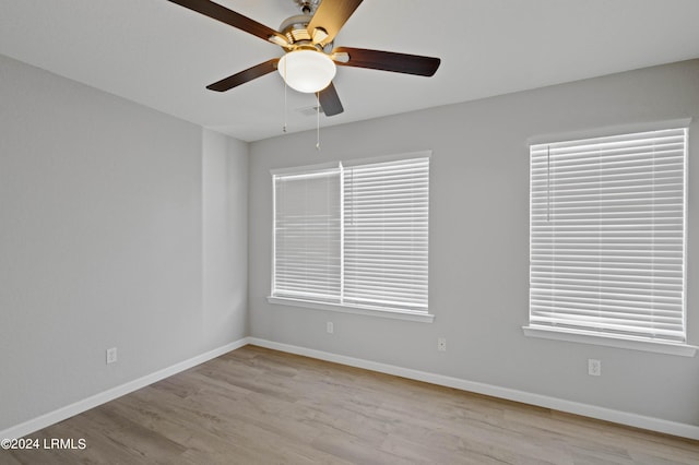 unfurnished room with ceiling fan, a wealth of natural light, and light hardwood / wood-style floors