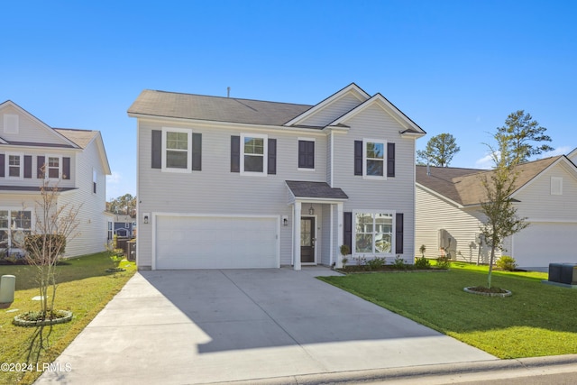 view of front of property featuring a garage, a front yard, and central air condition unit