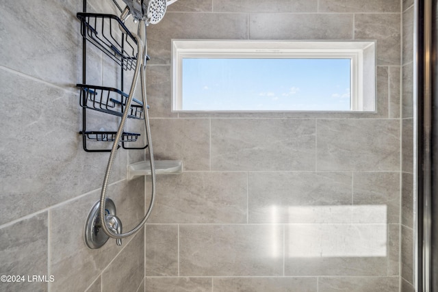 bathroom with tiled shower