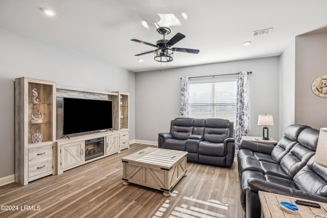 living room with hardwood / wood-style flooring and ceiling fan