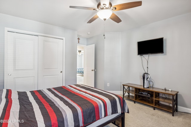 bedroom featuring light carpet, ceiling fan, and a closet