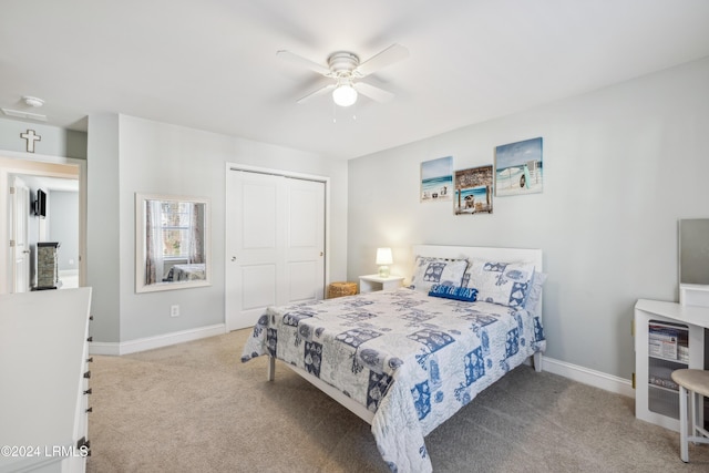 carpeted bedroom featuring ceiling fan and a closet