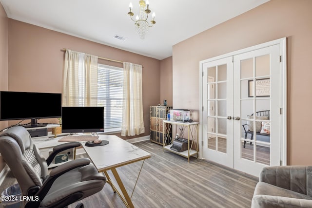 office with french doors, a chandelier, and light hardwood / wood-style flooring