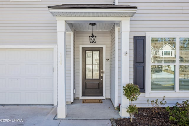 view of exterior entry with a garage