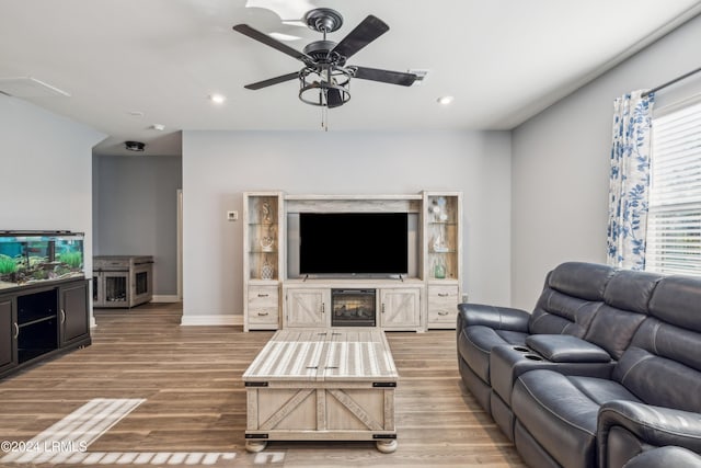 living room with hardwood / wood-style floors and ceiling fan