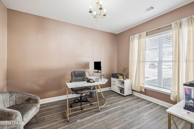 office with hardwood / wood-style floors, a wealth of natural light, and a chandelier