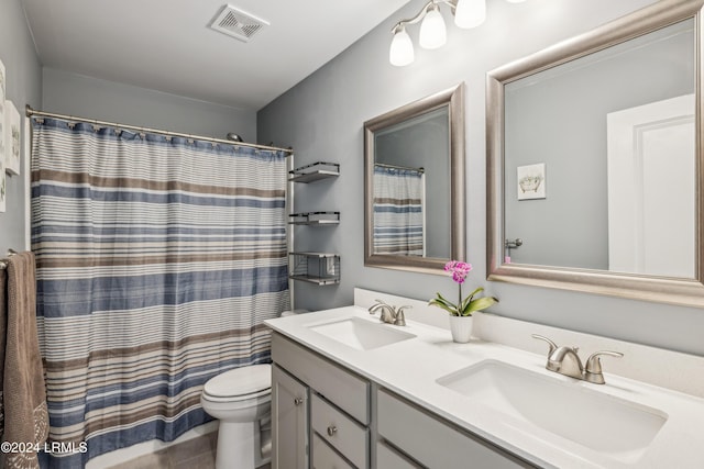 bathroom featuring walk in shower, vanity, and toilet