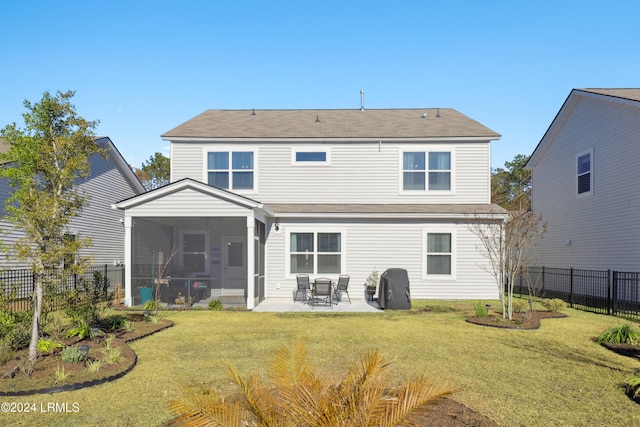 rear view of house with a patio, a sunroom, and a yard