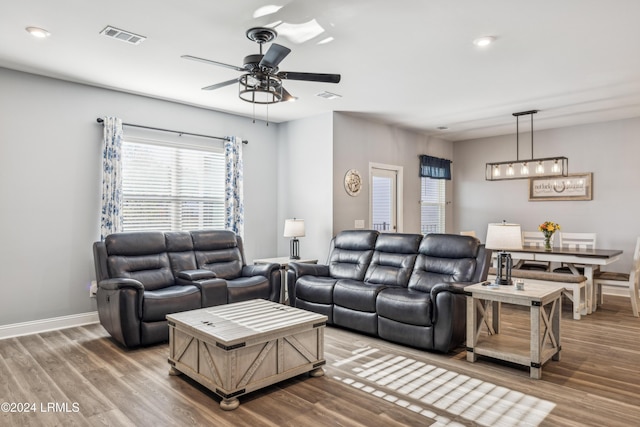 living room with ceiling fan and wood-type flooring