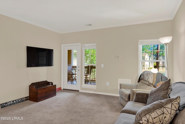 living room with a wealth of natural light, carpet, and visible vents