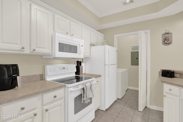 kitchen featuring visible vents, washing machine and dryer, light tile patterned flooring, white cabinetry, and white appliances