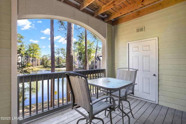 wooden deck with outdoor dining space and visible vents