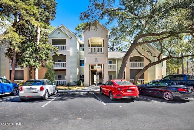 view of building exterior with uncovered parking