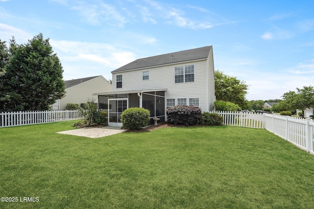 rear view of property with a fenced backyard, a sunroom, and a lawn