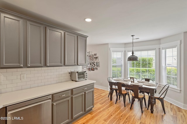 dining space with light wood-type flooring, recessed lighting, and baseboards
