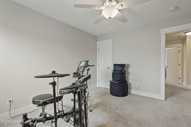 workout area featuring a ceiling fan, carpet floors, and baseboards