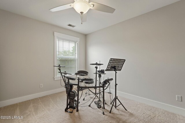 interior space featuring visible vents, a ceiling fan, and baseboards