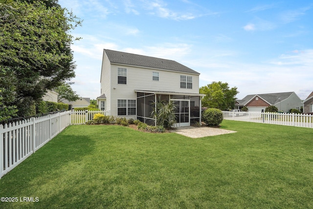 rear view of property with a fenced backyard, a yard, and a sunroom