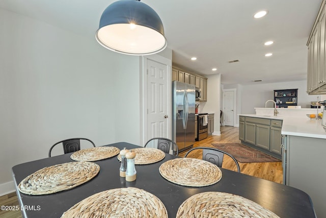 dining room with visible vents, recessed lighting, light wood finished floors, and baseboards