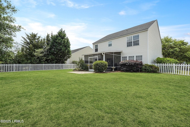 back of house with a sunroom, a lawn, and a fenced backyard