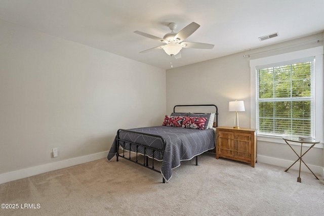 carpeted bedroom featuring visible vents, ceiling fan, and baseboards