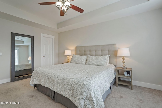 bedroom with ceiling fan, light colored carpet, and baseboards