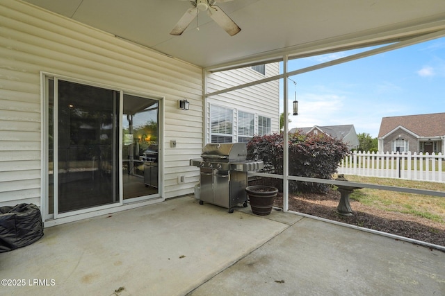 sunroom featuring a ceiling fan
