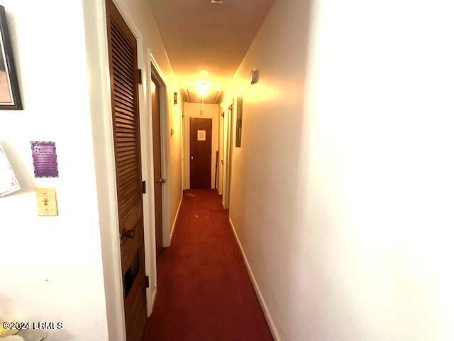 corridor with dark carpet