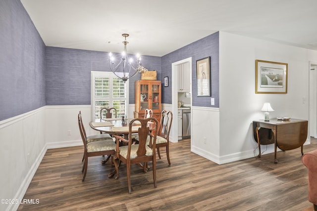 dining area with a notable chandelier and dark hardwood / wood-style floors