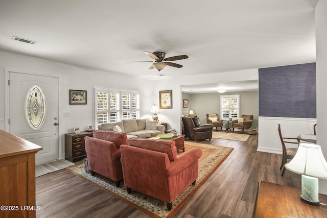 living room featuring dark hardwood / wood-style flooring and ceiling fan