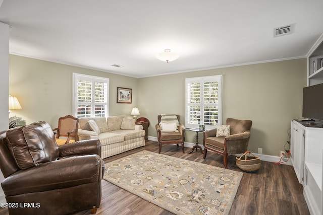 living room with ornamental molding, dark hardwood / wood-style flooring, and plenty of natural light