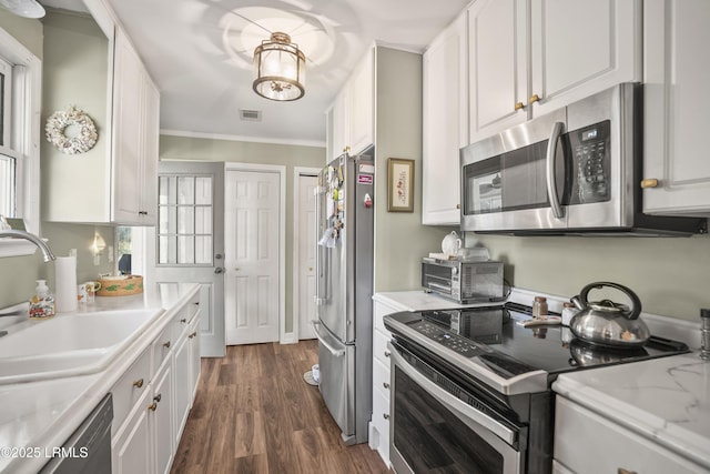 kitchen featuring sink, appliances with stainless steel finishes, white cabinets, and dark hardwood / wood-style floors