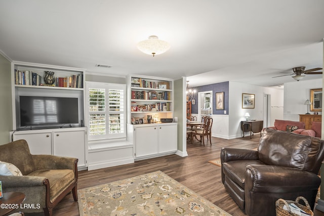 living room featuring ceiling fan with notable chandelier and dark hardwood / wood-style floors