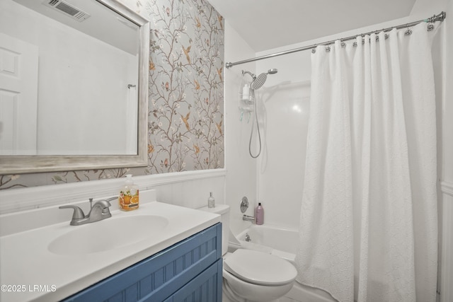 full bathroom featuring toilet, shower / bath combination with curtain, and vanity