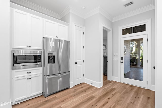 7 Canton Row, Beaufort, SC 29906 - kitchen featuring appliances with stainless steel finishes, light wood-style floors, white cabinetry, and ornamental molding