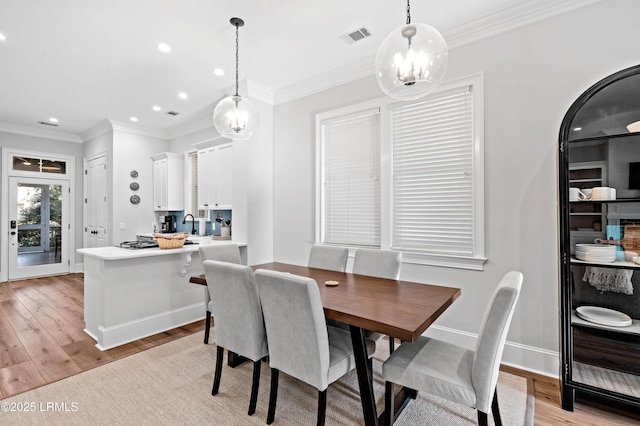 7 Canton Row, Beaufort, SC 29906 - dining room with light wood finished floors, recessed lighting, a chandelier, and ornamental molding