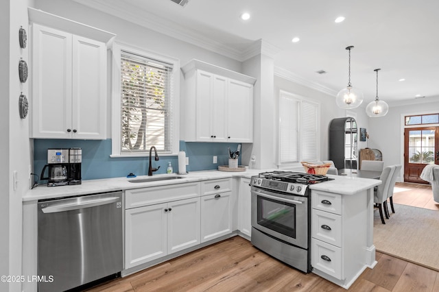 7 Canton Row, Beaufort, SC 29906 - kitchen featuring stainless steel appliances, a peninsula, white cabinets, recessed lighting, and light wood-style floors
