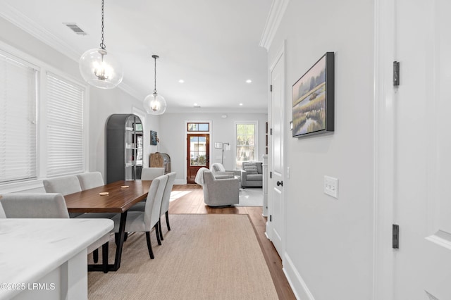 7 Canton Row, Beaufort, SC 29906 - dining space with light wood-type flooring, arched walkways, ornamental molding, and recessed lighting